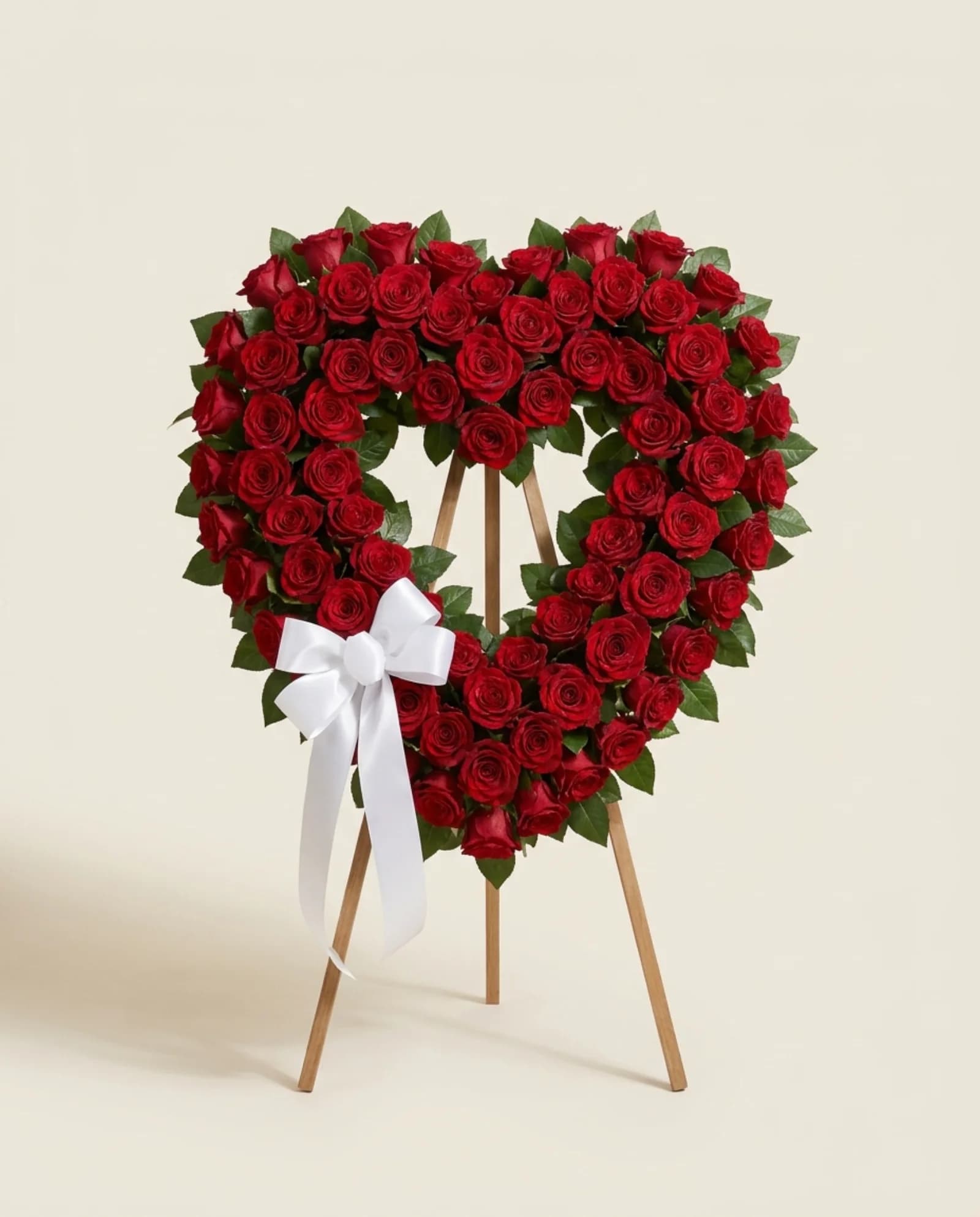 Coração de rosas vermelhas com laço de cetim.